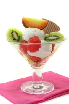 Fruit sundae with fresh kiwi, peach and melon