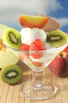 Fruit sundae with fresh kiwi, peach and melon