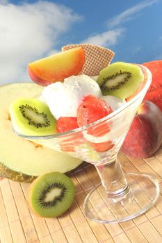 Fruit sundae with fresh kiwi, peach and melon