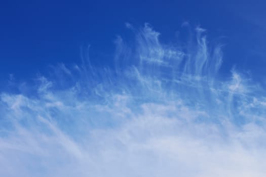 Easy crests of white clouds against the background of blue sky