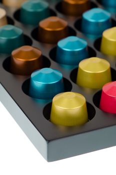 Coffee capsules for a coffee machine, close up view isolated on white background.
