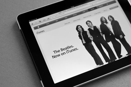Kiev, Ukraine - May 17, 2011: Apple Ipad shows iTunes home page with information that the Beatles music are now available for downloading. Processed in BW.