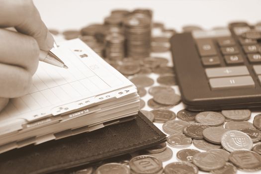 Business concept - diary, coins and calculator 