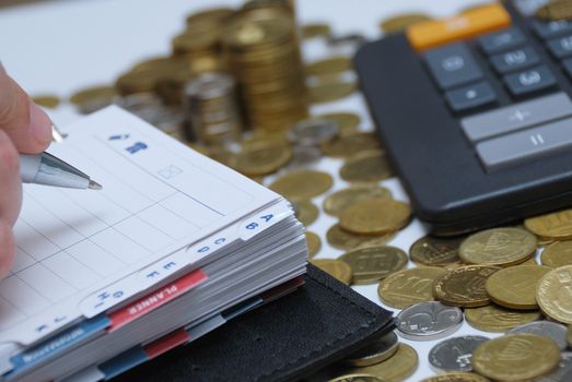 Business concept - diary, coins and calculator 