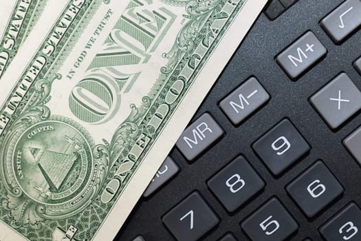 Money on keypad of a calculator close up