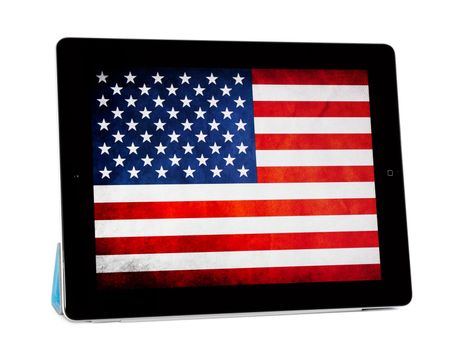 Kiev, Ukraine - Jule 10, 2011 - Apple Ipad2 with blue Smart cover standing on isolated white background. This second generation Ipad 2 is designed and development by Apple inc. and launched in march 2011. Apple iPad2 with folded Smart cover, isolated on white background. American flag on screen.