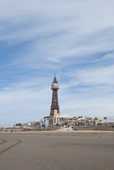The Famous Tower of Blackpool taken from the beach under a blue sky