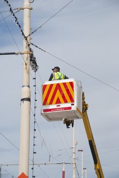 Electrician on Cherry Picker installing decorative Lighting