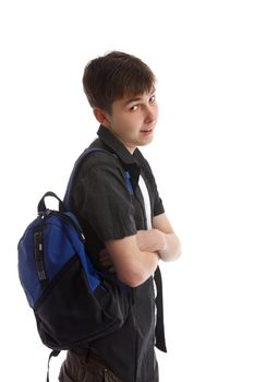 Teen student with backpack slung over shoulder.   He has his arms casually folded and is looking over and smiling.