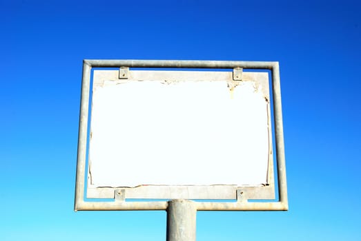 Old rusty blank billboard on sky background