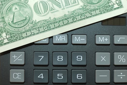 Money on keypad of a calculator close up