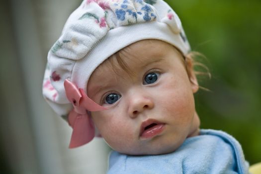 childhood: nice baby on the cap with bow