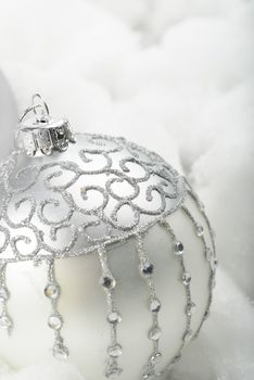 Silver christmas ornament in a white cotton snow