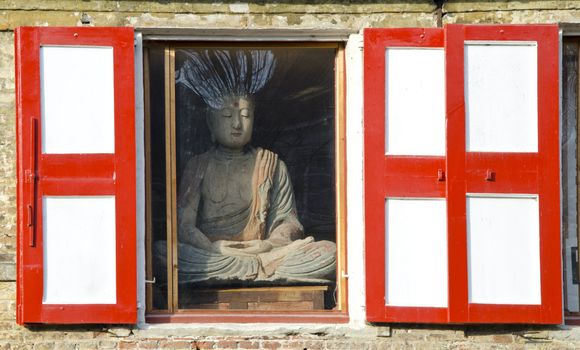 Buddha in the house window