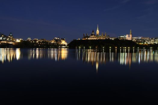 The skyline of Ottawa, Ontario, Canada at night, with Parliament Hill in the background.