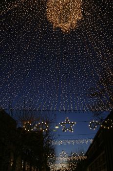 Illuminated urban street - at Christmas time. Focus on "stars"