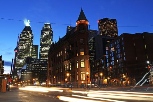 Toronto, Canada: Intersection of Wellington St., Front St., and Church St. at night with the iconic Flatiron Building.