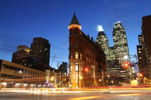 Toronto, Canada: Intersection of Wellington St., Front St., and Church St. at night with the iconic Flatiron Building.