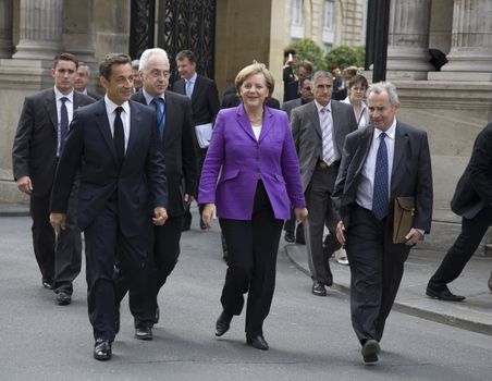 PARIS, FRANCE - JUNE 11 - 2009: French president Nicolas Sarkozy (front left) and German chancellor Angela Merkel  (front middle) outside the Elysee Palace on their way to lunch.