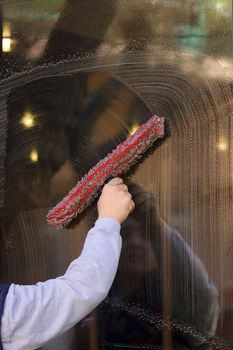 A worker is cleaning the window