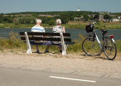 old men on a bench, looking over the river