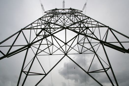 Close view of a high tension pole on a cloudy day