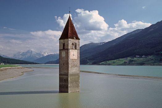 Church tower near Graun, in the Reschensee in South Tyrol, Italy. Graun, Kirchturm, Reschensee