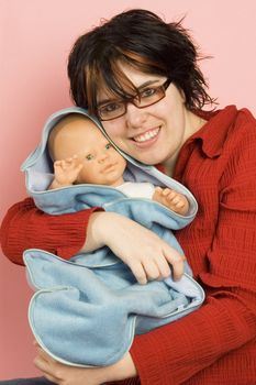 young beatiful woman holding a little babydoll