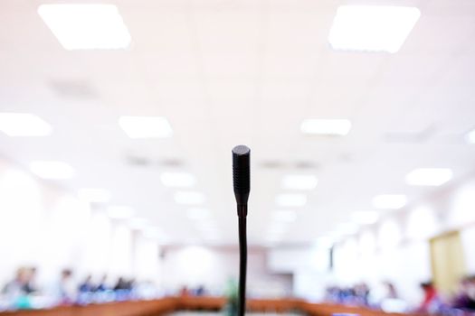 microphone in a big conference hall with numerous chairs.