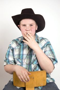 young handsome cowboy smoking a cigarette