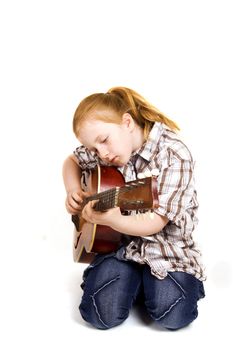 little girl playing on a guitar