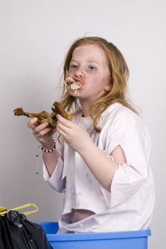 homeless girl is eating a piece of chicken