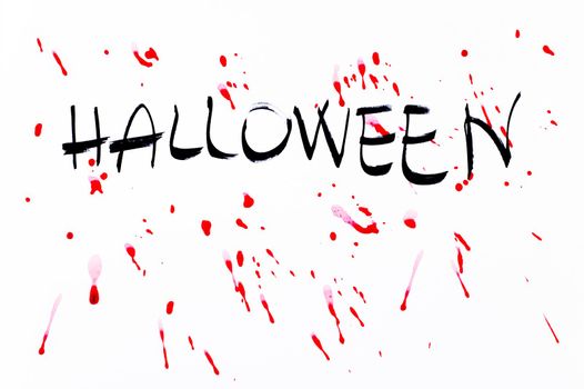 Halloween word on white background with blood splatters