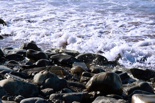 waves rolling over rocks on an irish beach
