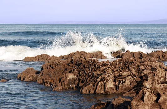 waves rolling over rocks on an irish beach