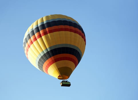 Yellow hot air balloon with color sky, view from bottom, landscape, copy space
