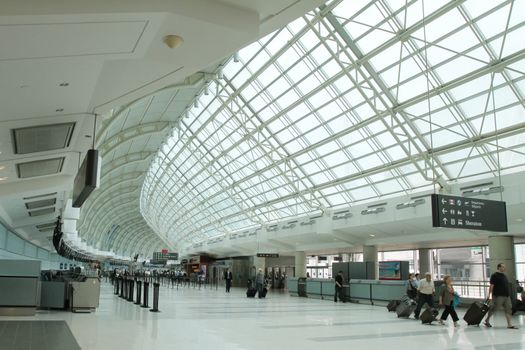 Toronto, Canada - June 16, 2011: Travellers walk through Terminal 3 of Toronto Pearson International Airport.