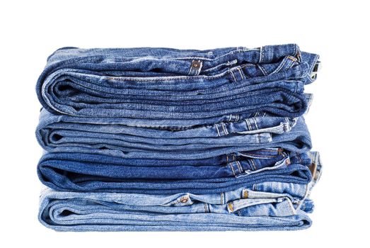 Stack of four various shades blue jeans - isolated