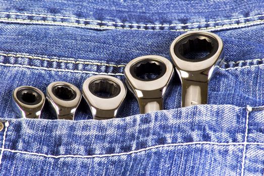 Five wrenches in a blue jeans pocket