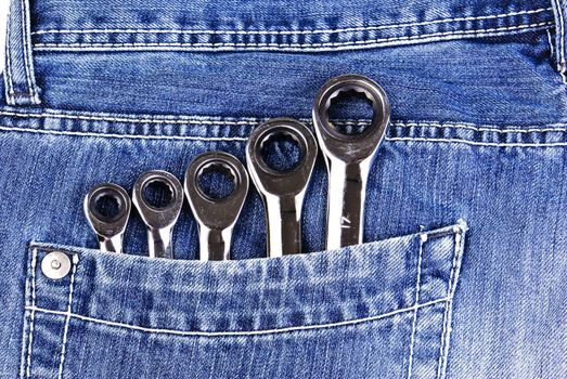 Five wrenches in a blue jeans pocket