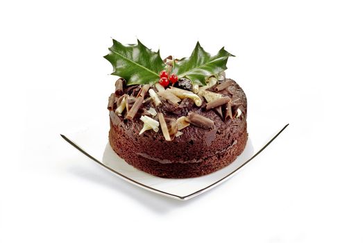 Chocolate cake with holly and red berries - isolated
