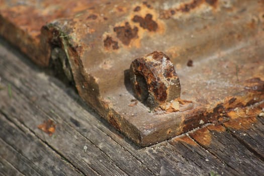 Old railway sleeper with rusty plate, placed in a garden in Norway.