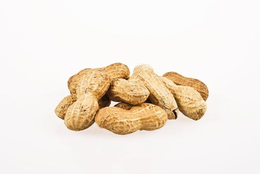 Several peanuts in shells over white background