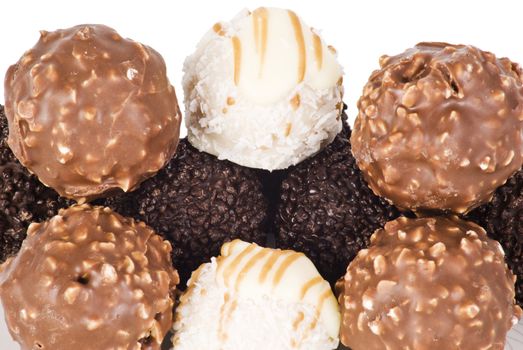 Several ball chocolates over white background