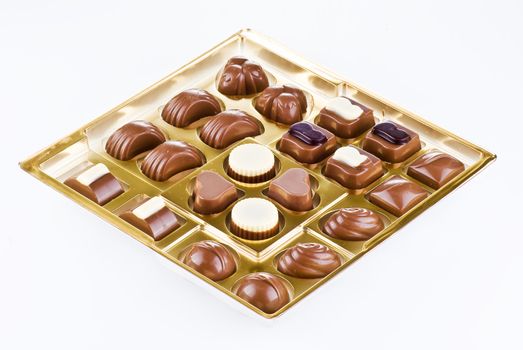 Assorted chocolates in the gold tray