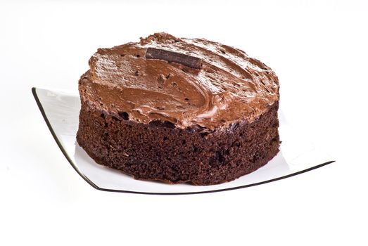 Dark brown chocolate cake over white background