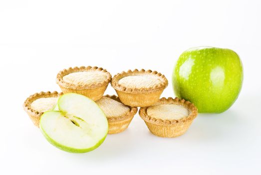 Freshly made apple pies over white background
