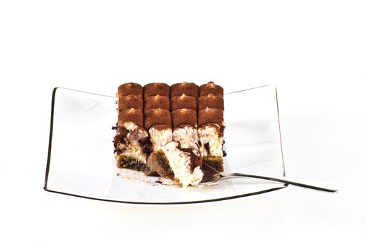 Tiramisu cake on the plate over white background
