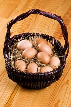 Fresh farm eggs in the basket with hay