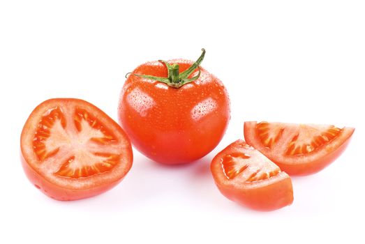 Fresh tomato with one half and two quarters over white 